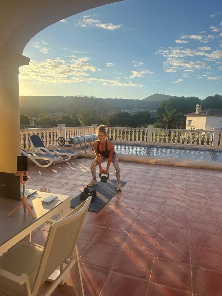 Client doing an outdoor kettlebell workout during a live online coaching class